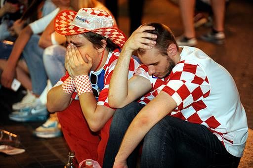 Croatian football fans react June 23, 2014 in the Croatian capital Zagreb's main square after Croatia lost 1-3 in their 2014 FIFA World Cup group A football match against Mexico. Several thousand people gathered at Zagreb's main square to watch the match between Mexico and Croatia on a giant screen. AFP