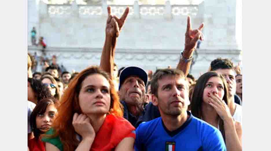 An Italy fan gestures as he reacts to the expulsion of Italian footballer Claudio Marchisio as he watches the FIFA World Cup 2014 Group D football match Italy vs Uruguay on a giant screen in central Rome on June 24 , 2014. AFP