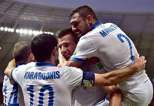 Greece's midfielder Andreas Samaris (C) celebrates with teammates after scoring a goal during the Group C football match between Greece and Ivory Coast at the Castelao Stadium in Fortaleza during the 2014 FIFA World Cup on June 24, 2014. AFP