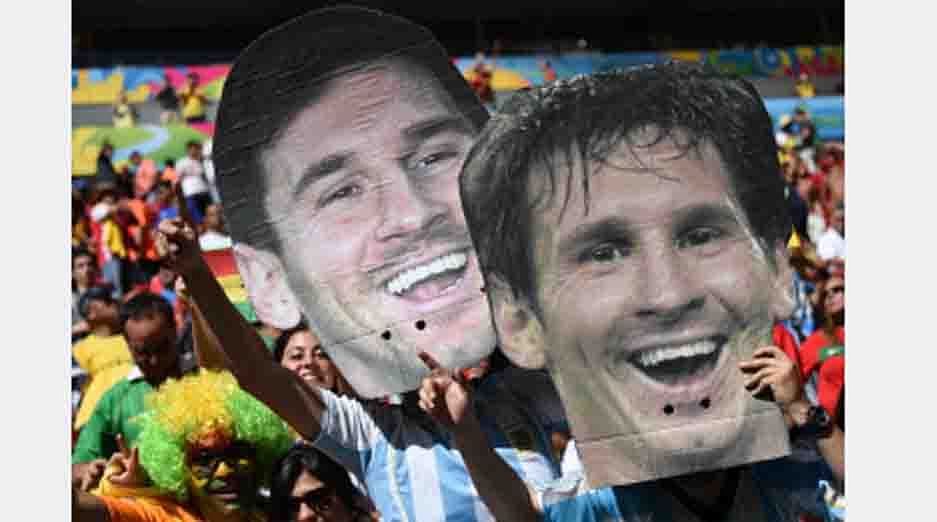 Argentina fans hold up portraits of Argentinian player Lionel Messi during the Group G football match between Portugal and Ghana at the Mane Garrincha National Stadium in Brasilia during the 2014 FIFA World Cup on June 26, 2014. AFP