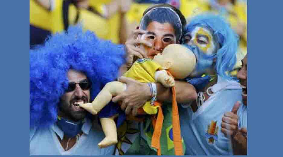 Fans of Uruguay hold a baby doll dressed in Brazil jersey before their 2014 World Cup round of 16 game against Colombia at the Maracana stadium in Rio de Janeiro on June 28, 2014. Reuters