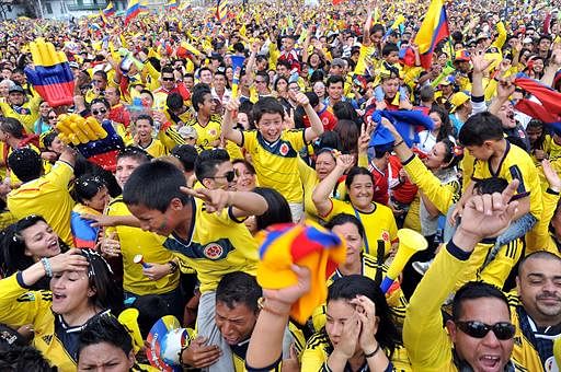 Colombian fans celebrate during the live broadcasting of the Brazil 2014 FIFA World Cup Round of 16 football match between Colombia and Uruguay, in Bogota, on June 28, 2014. Colombia won 2-0. AFP
