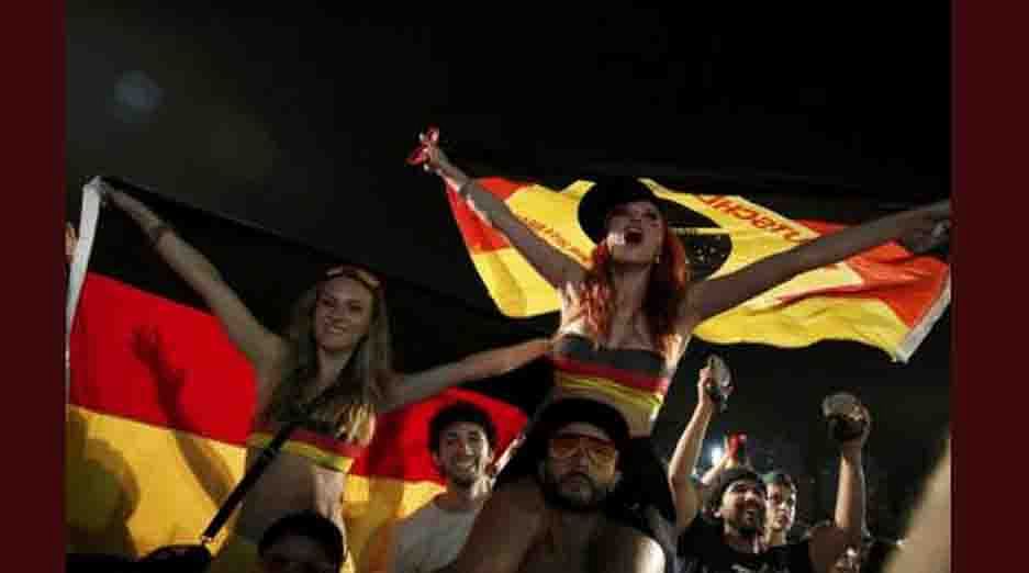 German soccer fans celebrate at the end of the 2014 World Cup soccer match between Germany and Algeria during a broadcast at Copacabana beach in Rio de Janeiro, June 30, 2014. Reuters