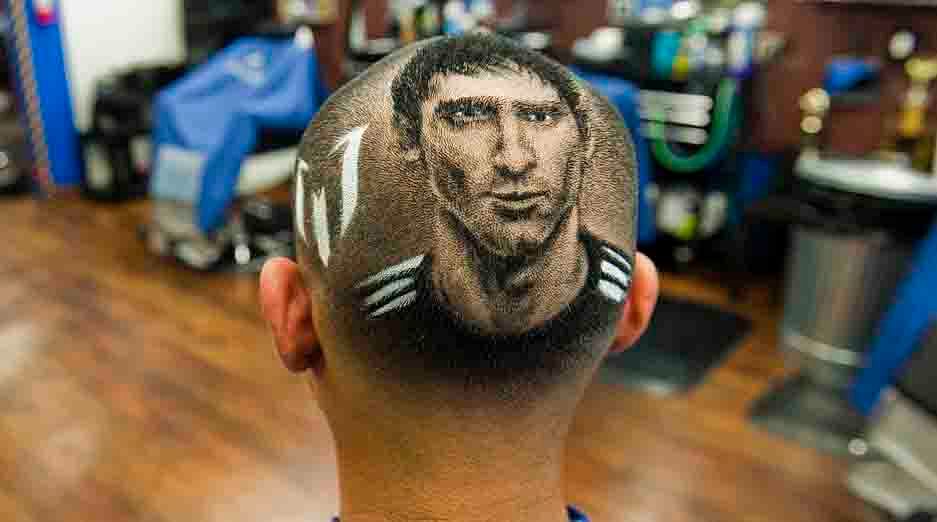 An Argentine soccer player Lionel Messi is cut onto the head of a customer ahead of World Cup match between Argentina and Switzerland at the barbershop in Texas on June 30, 2014. Reuters