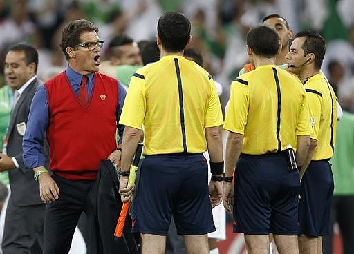 Russia's Italian coach Fabio Capello (L) reacts in front of the referees at the end of their Group H football match against Russia at the Baixada Arena in Curitiba during the 2014 FIFA World Cup on June 26, 2014. AFP