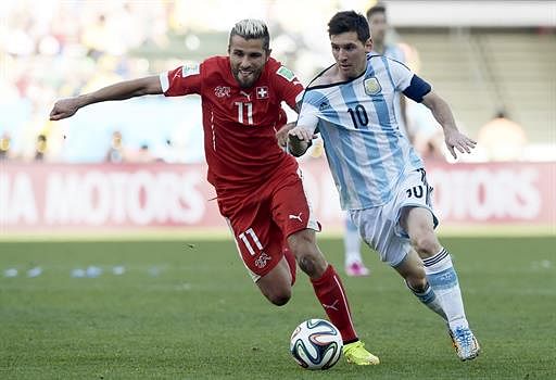 Argentina's forward and captain Lionel Messi (R) and Switzerland's midfielder Valon Behrami vie for the ball during a Round of 16 football match between Argentina and Switzerland at Corinthians Arena in Sao Paulo during the 2014 FIFA World Cup on July 1, 2014. AFP