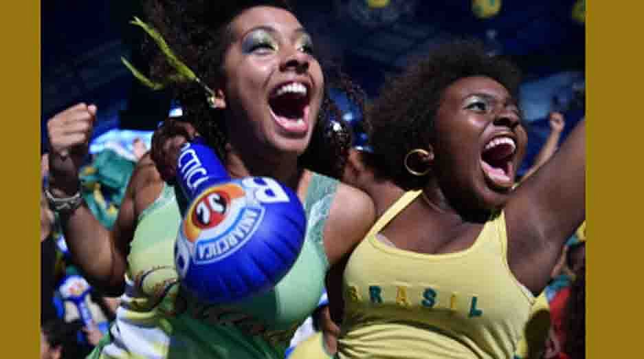 Fans of Brazil celebrate during a live football screening at Portela Samba School in Rio de Janeiro on July 4, 2014, after Brazil