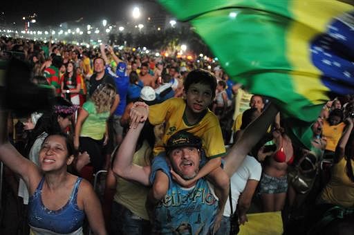 Brazilian fans celebrate during the Fan Fest at Copacabana beach in Rio de Janeiro, Brazil, on July 4, 2014 after the squad beat Colombia in a FIFA World Cup quarter-final football match. AFP