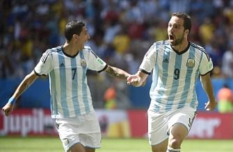 Argentina's forward Gonzalo Higuain (R) celebrates with Argentina's midfielder Angel Di Maria (L) after scoring during a quarter-final football match between Argentina and Belgium at the Mane Garrincha National Stadium in Brasilia during the 2014 FIFA World Cup on July 5, 2014. AFP