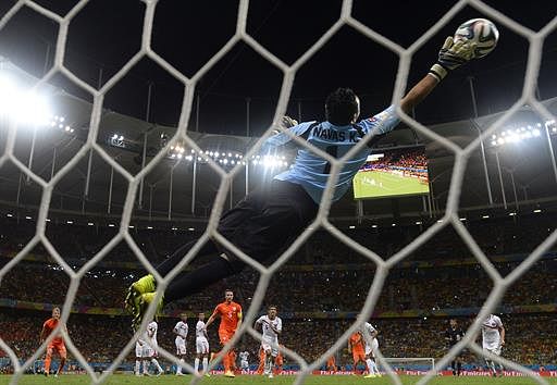 Costa Rica's goalkeeper Keylor Navas makes a save during a quarter-final football match between Netherlands and Costa Rica at the Fonte Nova Arena in Salvador during the 2014 FIFA World Cup on July 5, 2014. AFP