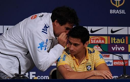 Brazilian footballer Paulo Henrique Ganso (C) listens to the director of the Brazilian national team's communication office, Rodrigo Paiva, during a press conference held with captain Lucio, before a training session in Campana, Buenos Aires, during the 2011 Copa America tournament on July 11, 2011. AFP
