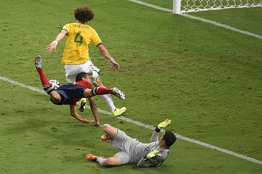 Colombia's forward Carlos Bacca (C) challenges Brazil's goalkeeper Julio Cesar (R) and Brazil's defender David Luiz (L) during the quarter-final football match between Brazil and Colombia at the Castelao Stadium in Fortaleza during the 2014 FIFA World Cup on July 4, 2014. AFP