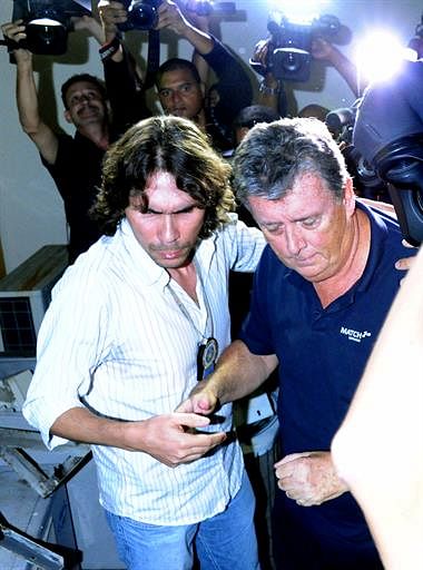 The CEO of Match Hospitality, a subsidary company of FIFA in charge of World Cup ticket packages, Raymond Whelan (R), arrives at a police station in Rio de Janeiro after being arrested accused of leading a network that illegal sold game passes, on July 7, 2014. AFP