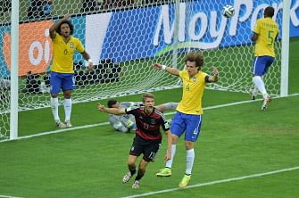 Germany's forward Thomas Mueller (C) celebrates after he scored their first goal during the semi-final football match between Brazil and Germany at The Mineirao Stadium in Belo Horizonte during the 2014 FIFA World Cup on July 8, 2014. AFP