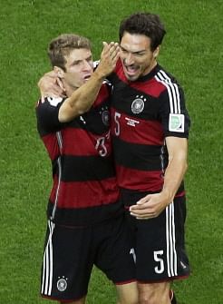 Germany's forward Thomas Mueller (L) celebrates with Germany's defender Mats Hummels after scoring during the semi-final football match between Brazil and Germany at The Mineirao Stadium in Belo Horizonte on July 8, 2014, during the 2014 FIFA World Cup. AFP