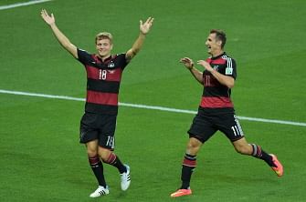 Germany's midfielder Toni Kroos (L) celebrates with Germany's forward Miroslav Klose after Kroos scored his team's third goal during the semi-final football match between Brazil and Germany at The Mineirao Stadium in Belo Horizonte during the 2014 FIFA World Cup on July 8, 2014. AFP