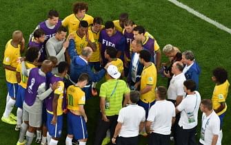 Brazil's coach Luiz Felipe Scolari (C) speaks to his players after losing the semi-final football match between Brazil and Germany at The Mineirao Stadium in Belo Horizonte on July 8, 2014, during the 2014 FIFA World Cup. AFP