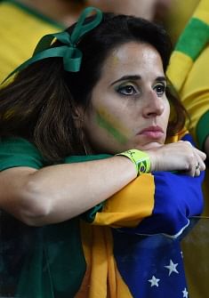 A Brazilian fan reacts during the semi-final football match between Brazil and Germany at The Mineirao Stadium in Belo Horizonte during the 2014 FIFA World Cup on July 8, 2014. AFP