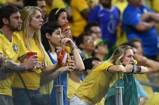Brazilian fans react during the semi-final football match between Brazil and Germany at The Mineirao Stadium in Belo Horizonte during the 2014 FIFA World Cup on July 8, 2014. AFP