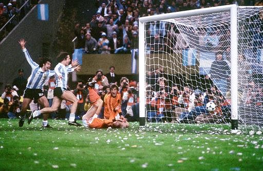 Argentinian midfielder Mario Kempes (L), who just scored his second goal, and forward Daniel Bertoni celebrate in front of Dutch defenders Wim Suurbier (on ground) and Jan Poortvliet, 25 June 1978 in Buenos Aires, during the extra time period of the World Cup soccer final. Kempes gave Argentina a 2-1 lead and Bertoni later scored a third goal to give Argentina its first-ever title with a 3-1 victory over the Netherlands. AFP