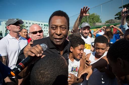Brazilian former football star Pele arrives for the inauguration of a football pitch donated by Switzerland's watch company Hublot at Jacarezinho shantytown in Rio de Janeiro, Brazil on June 27, 2014. AFP