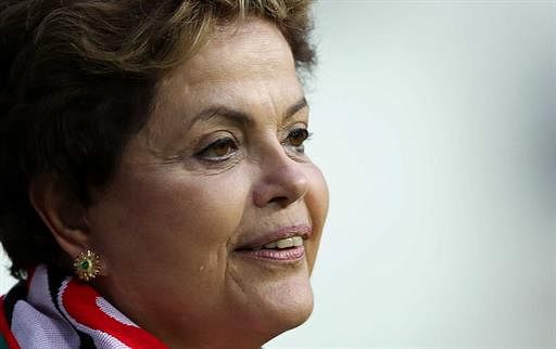 Brazilian President Dilma Rousseff looks on as she visits Arena da Baixada stadium wich will host four matches of the upcoming FIFA World Cup Brazil 2014, in Curitiba, Brazil on May 9, 2014. AFP