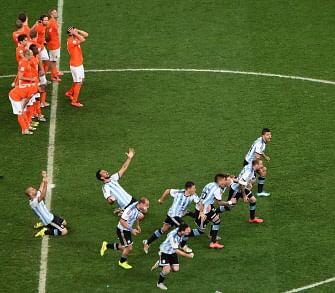 Argentina's players celebrate after midfielder Maxi Rodriguez scored during a penalty shoot-out of the semi-final football match between Netherlands and Argentina of the FIFA World Cup at The Corinthians Arena in Sao Paulo on July 9, 2014. AFP