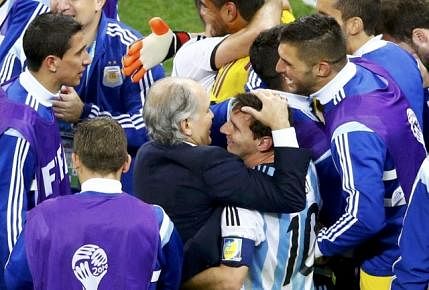 Argentina's coach Alejandro Sabella hugs Lionel Messi after winning the 2014 World Cup semi-finals between Argentina and the Netherlands at the Corinthians arena in Sao Paulo on July 9, 2014. Reuters