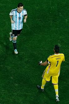 Argentina's goalkeeper Sergio Romero (R) and Argentina's forward Lionel Messi celebrate during a penalty shoot-out of the semi-final football match between Netherlands and Argentina of the FIFA World Cup at The Corinthians Arena in Sao Paulo on July 9, 2014. AFP
