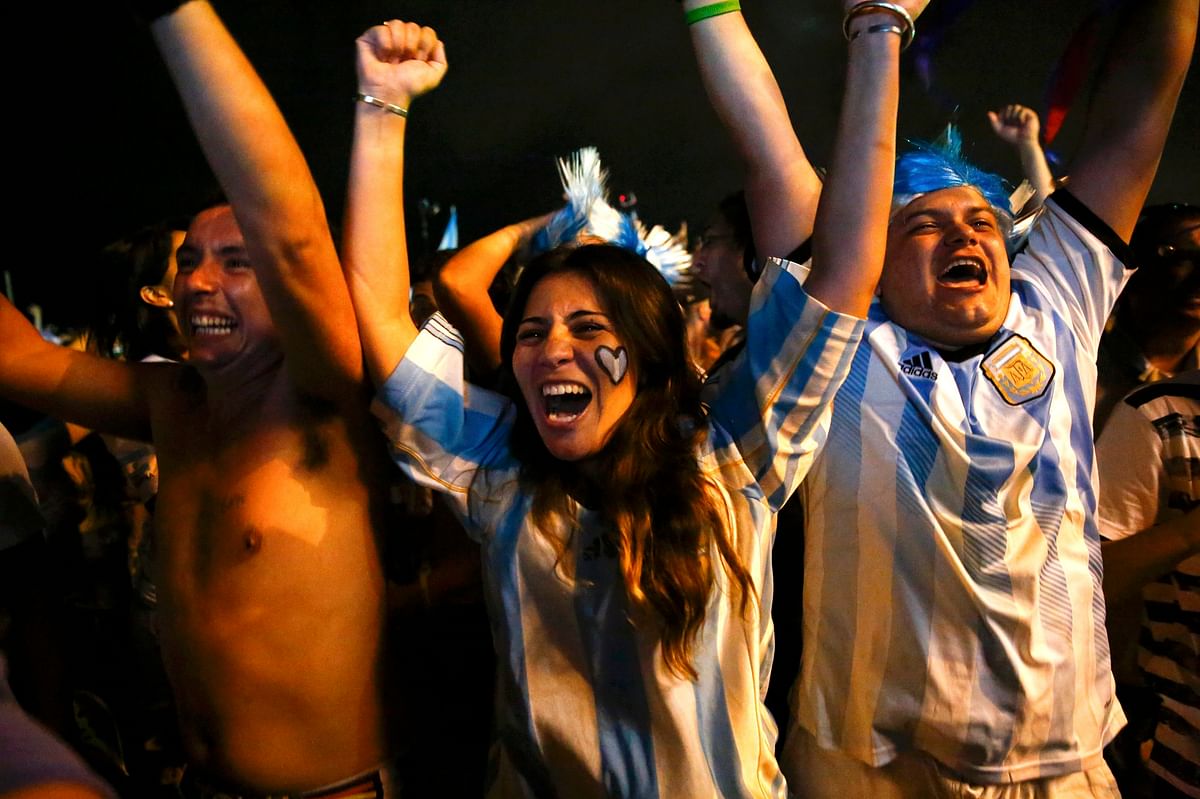 Argentina fans celebrate after their team won the 2014 World Cup semi-final match against the Netherlands as they watched at Copacabana beach in Rio de Janeiro on July 9, 2014. Reuters