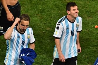 Argentina's forward Gonzalo Higuain (L) and Argentina's forward Lionel Messi celebrate after the semi-final football match between Netherlands and Argentina of the FIFA World Cup at The Corinthians Arena in Sao Paulo on July 9, 2014. AFP