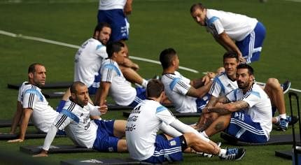 Argentina's Mascherano talks to Biglia during a training session ahead of their 2014 World Cup final match against Germany in Vespasiano. Reuters