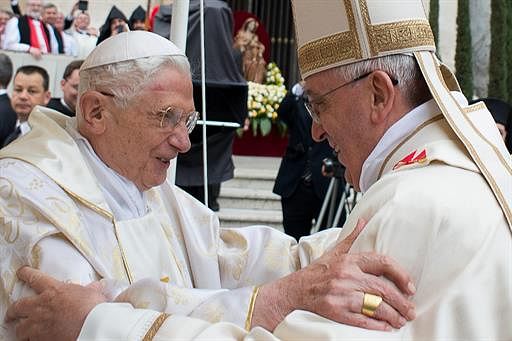 Pope Francis (R) meets with Pope emeritus Benedict XVI during the canonisation mass of Popes John XXIII and John Paul II on St Peter's square at the Vatican on April 27, 2014. AFP