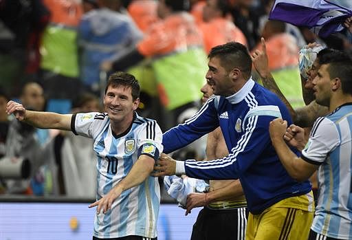 Argentina's forward and captain Lionel Messi (L) celebrates with his teammates after winning their FIFA World Cup semi-final match against the Netherlands in a penalty shoot-out following extra time at The Corinthians Arena in Sao Paulo on July 9, 2014. AFP