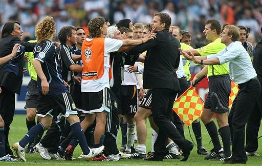 Members of both the German and Argentina squads get involved in a scuffle after Germany's victory in a penalty shootout at the end of the quarter-final World Cup football match between Germany and Argentina at Berlin's Olympic Stadium, 30 June 2006. Germany won 4-2 on penalty kicks after the match finished in extra time 1-1. AFP