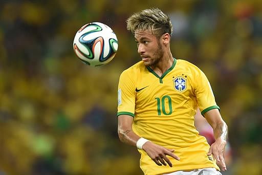 Brazil's forward Neymar eyes the ball during the quarter-final football match between Brazil and Colombia at the Castelao Stadium in Fortaleza during the 2014 FIFA World Cup on July 4, 2014. AFP