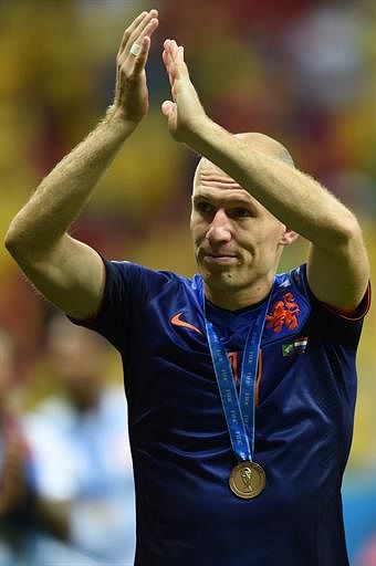 Netherlands' forward Arjen Robben celebrates after receiving a bronze medal at the end of the third place play-off football match between Brazil and Netherlands during the 2014 FIFA World Cup at the National Stadium in Brasilia on July 12, 2014. Netherlands won 3-0. AFP