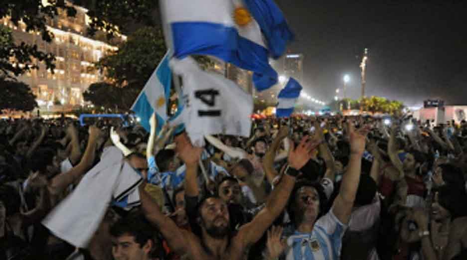 Argentinian fans hold their national flag during the Fan Fest at Copacabana beach in Rio de Janeiro, Brazil, on July 12, 2014 as Brazil and the Netherlands play the FIFA World Cup third-place match in Brasilia. Germany and Argentina will play the final on Sunday. AFP