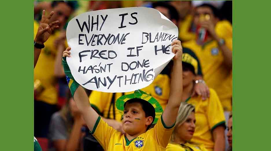 A fan of Brazil holds up a placard after the 2014 World Cup third-place playoff between Brazil and the Netherlands at the Brasilia national stadium in Brasilia on July 12, 2014. Reuters