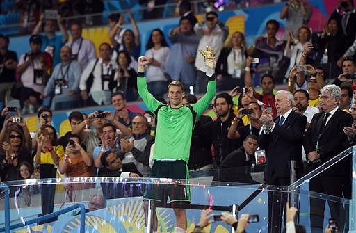 Germany's goalkeeper Manuel Neuer celebrates after receiving the Golden Glove award for best goalkeeper after Germany won the 2014 FIFA World Cup final football match between Germany and Argentina 1-0 following extra-time at the Maracana Stadium in Rio de Janeiro, Brazil, on July 13, 2014. AFP