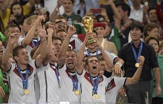 Germany's defender and captain Philipp Lahm holds up the World Cup trophy after winning the 2014 FIFA World Cup final football match between Germany and Argentina at the Maracana Stadium in Rio de Janeiro on July 13, 2014. AFP
