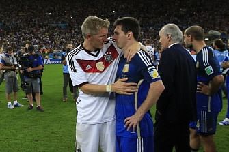 Germany's midfielder Bastian Schweinsteiger (L) conforts Argentina's forward Lionel Messi after the final football match between Germany and Argentina for the FIFA World Cup at The Maracana Stadium in Rio de Janeiro on July 13, 2014. AFP
