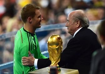 FIFA President Joseph Blatter congratulates Germany's goalkeeper Manuel Neuer after he won the golden glove award after the 2014 FIFA World Cup final football match between Germany and Argentina at the Maracana Stadium in Rio de Janeiro on July 13, 2014. AFP