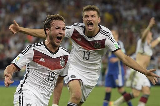 Germany's forward Mario Goetze (L) celebrates with his teammate Germany's forward Thomas Mueller after scoring a goal during the second half of extra-time during the 2014 FIFA World Cup final football match between Germany and Argentina at the Maracana Stadium in Rio de Janeiro, Brazil, on July 13, 2014. AFP