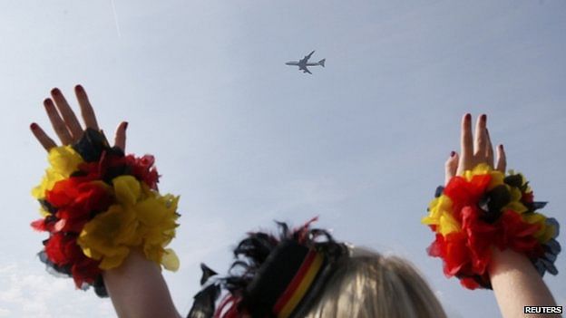 The winning team's Boeing 747 landed at Tegel airport after flying a lap of honour over the 'fan mile' in front of the landmark Brandenburg Gate