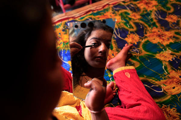A sex-worker is seen having her make up done at Kandapara brothel in Tangail on  March 5, 2012. Photo: Reuters