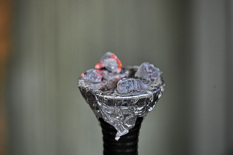 Charcoal burns over a 'hookah' device at a cafe in Singapore. Photo: AFP