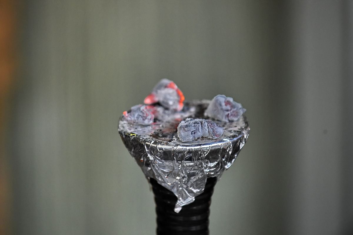 Charcoal burns over a 'hookah' device at a cafe in Singapore. Photo: AFP