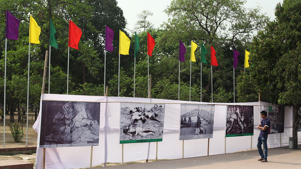 A visitors watch the atrocities of Pakistan occupation forces displayed in pictures outside the Independence Museum.