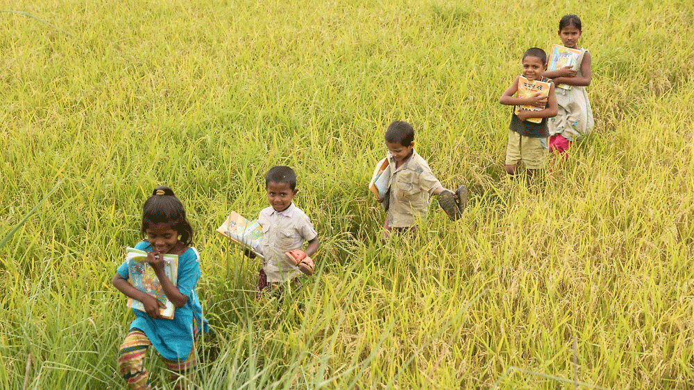 Children running back to their home after the school finishes, some even running with their shoes in hand at Nilagaon Ranaghat area of Sadar upazila in Sylhet on Sunday afternoon. Photo: Anis Mahmud, Sylhet